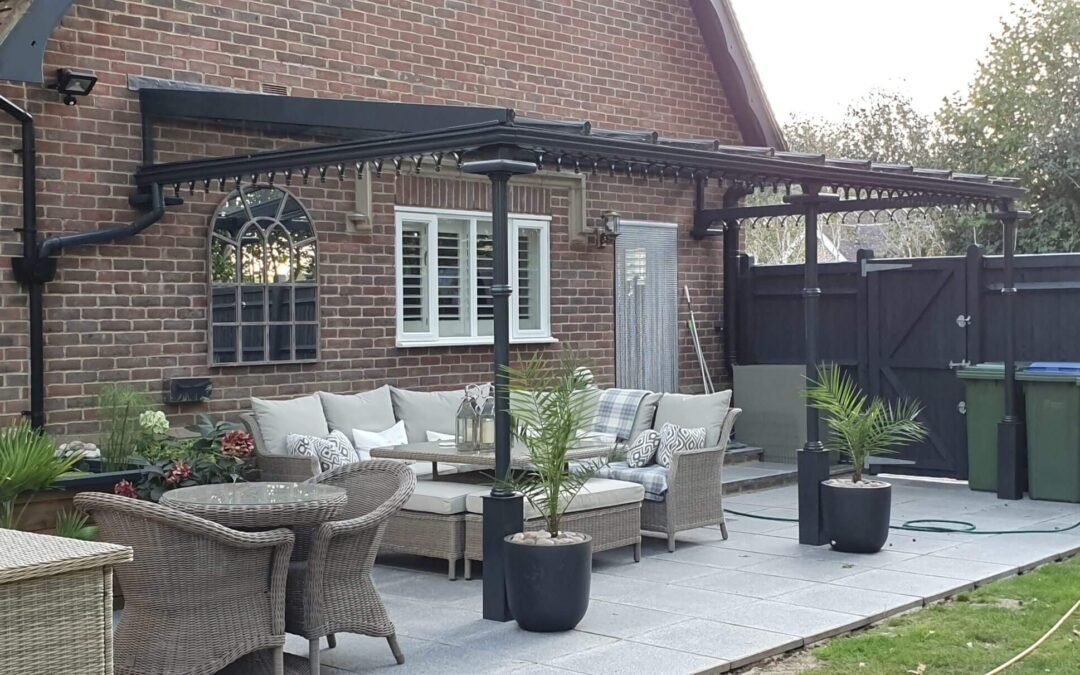 Black steel veranda lean-to system covering grey patio